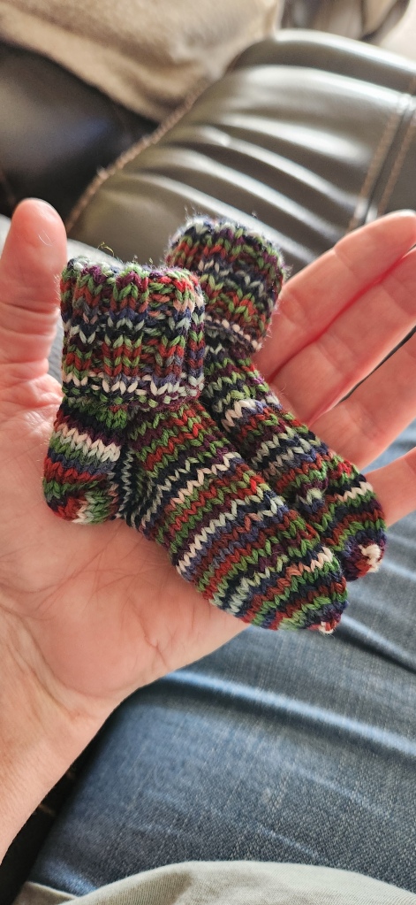 tiny pair of knit socks in my hand
